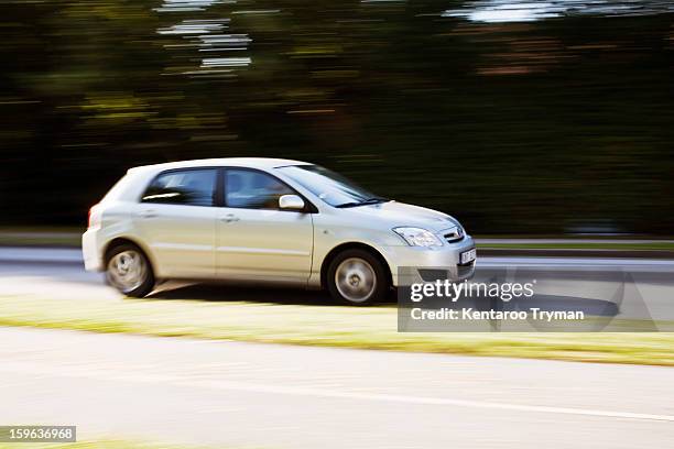 blurred motion of trees with vehicle moving rapidly on foreground - car moving stock pictures, royalty-free photos & images