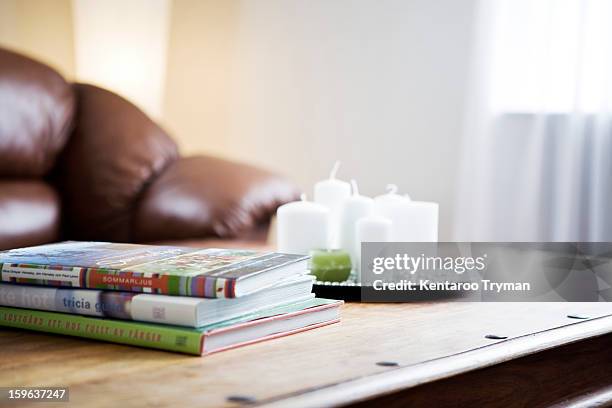 stack of books with a tray of candles on table - mesa de café imagens e fotografias de stock