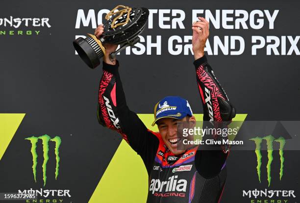 Aleix Espargaro of Spain celebrates his win on the podium with his trophy after the MotoGP of Great Britain - Race at Silverstone Circuit on August...