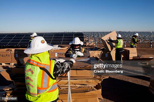 Contractors for First Solar Inc. Unload materials from boxes during construction of the Tenaska Imperial Solar Energy Center South project in...