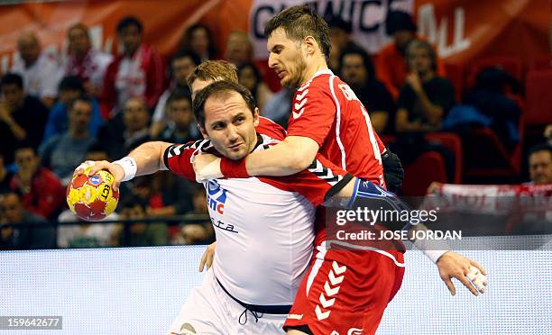 Serbia's pivot Alem Toskic vies with Poland's pivot Piotr Grabarczyk during the 23rd Men's Handball World Championships preliminary round Group C...