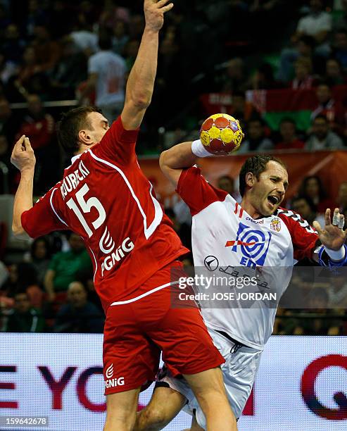 Poland's left back Michal Jurecki vies with Serbia's pivot Alem Toskic during the 23rd Men's Handball World Championships preliminary round Group C...