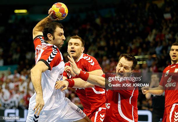 Serbia's centre back Nenad Vuckovic vies with Poland's centre back Michal Kubisztal during the 23rd Men's Handball World Championships preliminary...