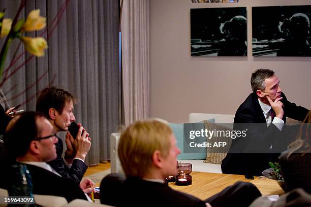 Norway's Prime Minister Jens Stoltenberg and Minister Of Foreign Affairs Espen Barth Eide and other aides watch a displayed press conference by...