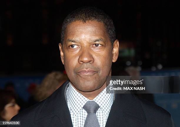 Actor Denzel Washington poses for pictures on the red carpet as he arrives to attend the UK Premiere of his latest film "Flight" in London's...