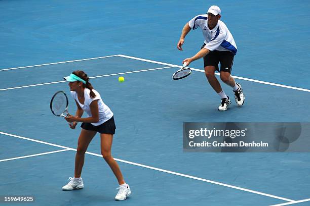 Bojana Bobusic of Australia and Chris Guccione of Australia compete in their doubles first round match against Anabel Medina Garrigues of Spain and...