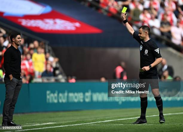 Mikel Arteta, Manager of Arsenal is shown a yellow card by Referee Stuart Attwell during The FA Community Shield match between Manchester City...