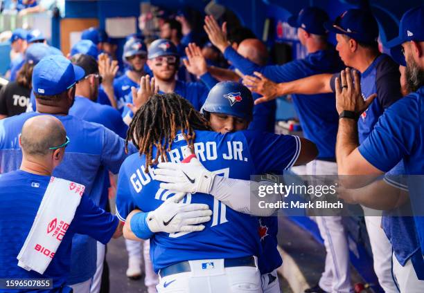 Daulton Varsho of the Toronto Blue Jays celebrates his three run home run with Vladimir Guerrero Jr. #27 against the Chicago Cubs during the second...