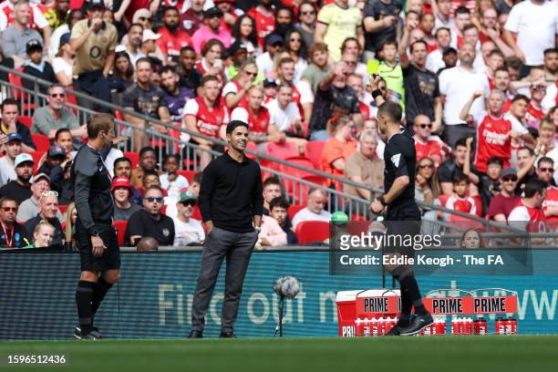 Mikel Arteta, Manager of Arsenal is shown a yellow card by Referee, Stuart Attwell during The FA Community Shield match between Manchester City...