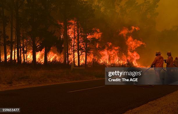 Firefighters prepare to defend the Glenmaggie Caravan Park in the large rural region of Gippsland January 18, 2013 near Glenmaggie, Victoria,...