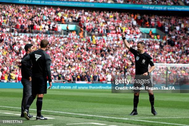 Mikel Arteta, Manager of Arsenal is shown a yellow card by Referee, Stuart Attwell during The FA Community Shield match between Manchester City...