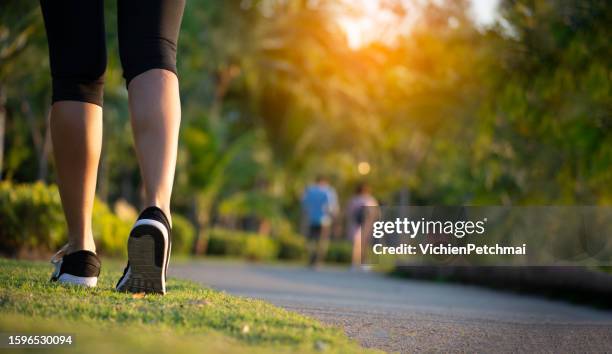 Happy Young beautiful asian female in sports bra running outdoor. Healthy and active lifestyle concept.