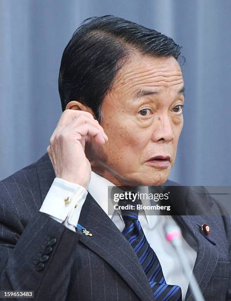 Taro Aso, Japan's deputy prime minister and finance minister, listens during a news conference in Tokyo, Japan, on Friday, Jan. 18, 2013. The...