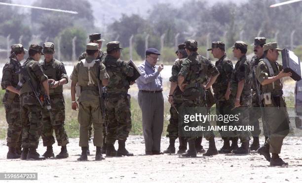 Peruvian defender of the settlement Jorge Santistevan talks with with military soldiers at the military airport in Moquegua, about 1300 kms south of...