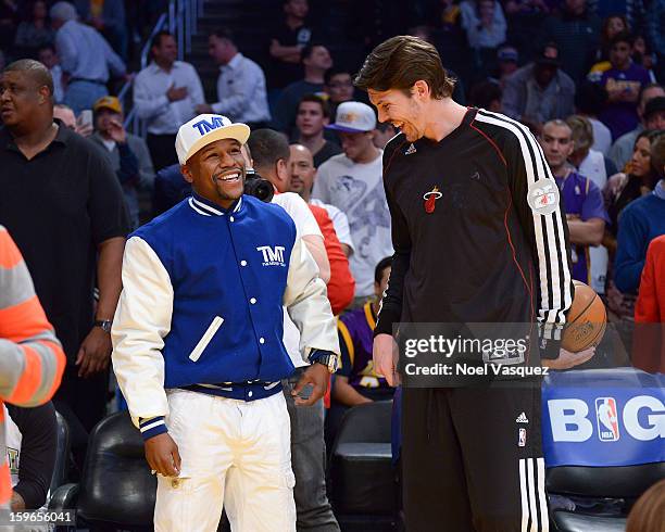 Floyd Mayweather Jr speaks with Mike Miller attend a basketball game between the Miami Heat and the Los Angeles Lakers at Staples Center on January...