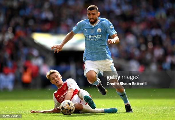 Martin Odegaard of Arsenal clashes with Mateo Kovacic of Manchester City during The FA Community Shield match between Manchester City against Arsenal...