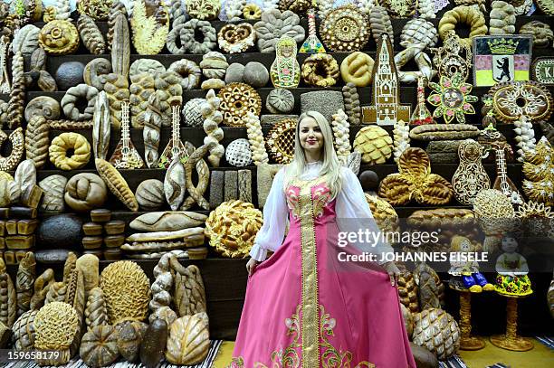 Hostess poses at a Russian backery booth during the opening of the Gruene Woche Agricultural Fair in Berlin on January 18, 2013. This year the...