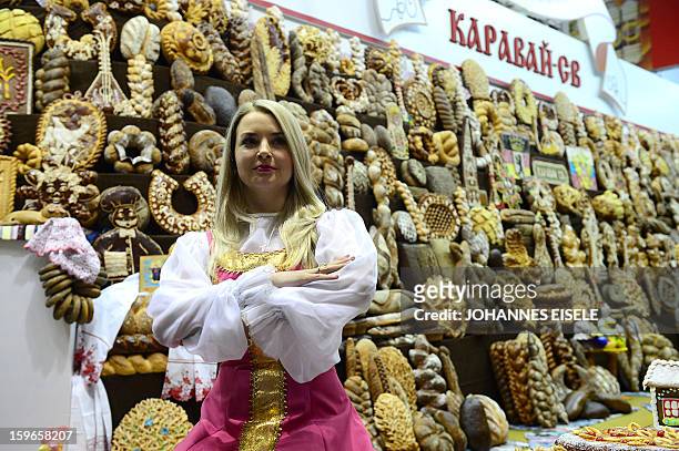 Hostess poses at a Russian backery and pastry booth during the opening of the Gruene Woche Agricultural Fair in Berlin on January 18, 2013. This year...