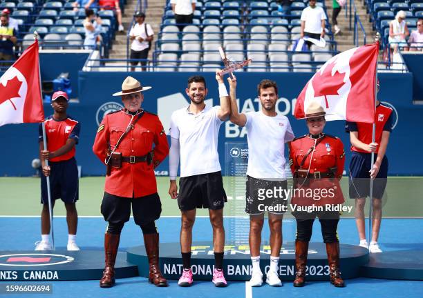 Marcelo Arevalo of El Salvador and Jean-Julien Rojer of The Netherlands celebrate with the champions trophy after victory against Rajeev Ram of the...