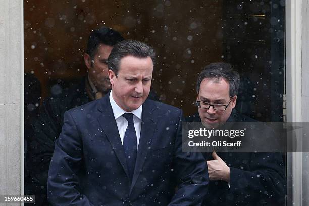 British Prime Minister David Cameron leaves Number 10 Downing Street in the snow as he travels to the House of Commons to deliver a statement on the...