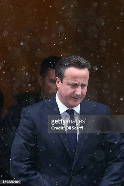 British Prime Minister David Cameron leaves Number 10 Downing Street in the snow as he travels to the House of Commons to deliver a statement on the...
