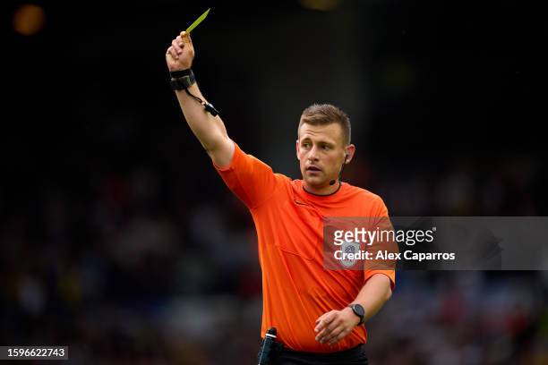Referee Josh Smith shows a yellow card during the Sky Bet Championship match between Leeds United and Cardiff City at Elland Road on August 06, 2023...