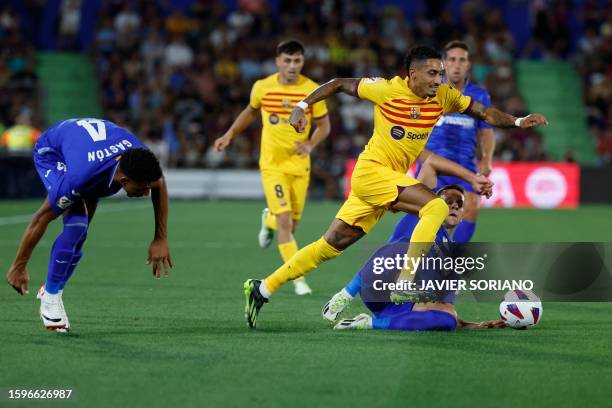 Barcelona's Brazilian forward Raphinha controls the ball during the Spanish Liga football match between Getafe CF and FC Barcelona at the Col....