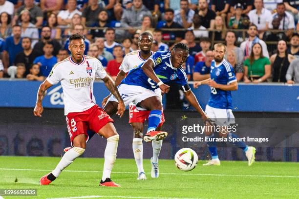 Jean-Ricner Bellegarde of Strasbourg attempts a kick while being defended by Corentin Tolisso of Lyon during the Ligue 1 Uber Eats match between RC...