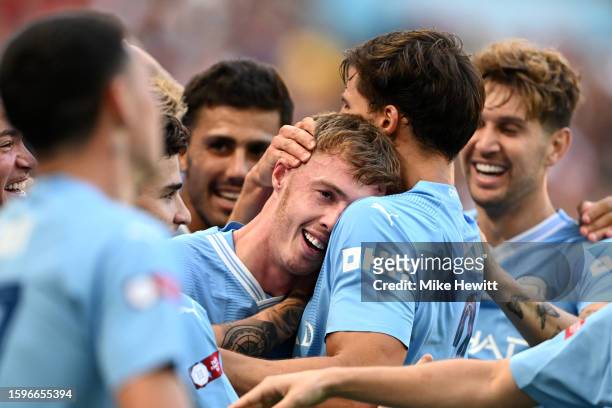 Cole Palmer of Manchester City celebrates after scoring the team's first goal with Ruben Dias of Manchester City during The FA Community Shield match...