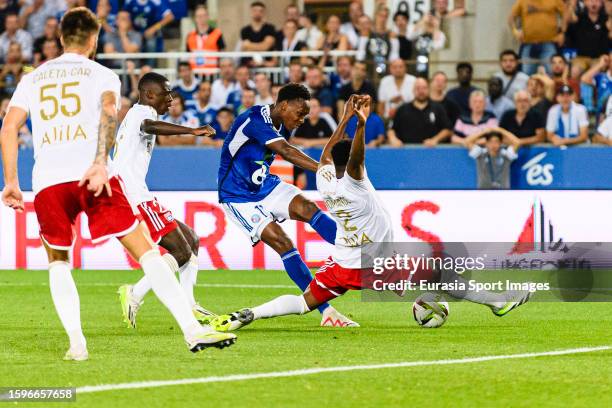 Emmanuel Emegha of Strasbourg attempts a kick while being defended by Sinaly Diomande of Lyon during the Ligue 1 Uber Eats match between RC...