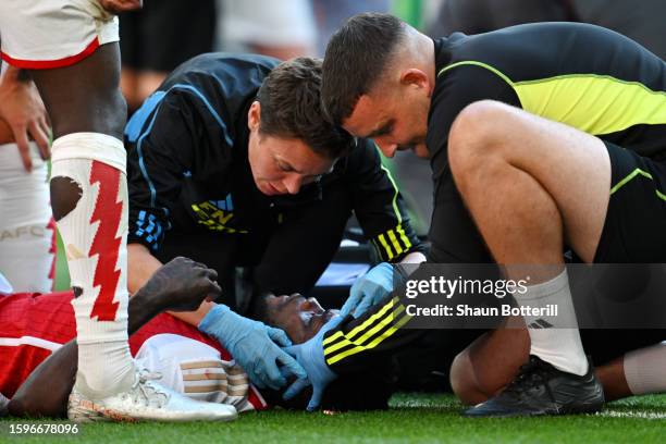 Thomas Partey of Arsenal receives medical treatment after going down with an injury during The FA Community Shield match between Manchester City...