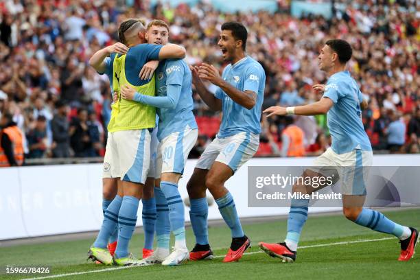 Cole Palmer of Manchester City celebrates after scoring the team's first goal with Kalvin Phillips, Rodri and Phil Foden of Manchester City during...