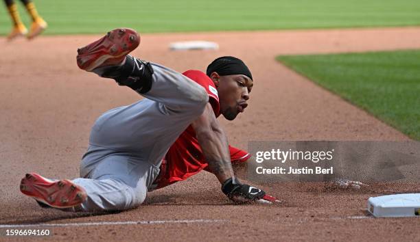 Will Benson of the Cincinnati Reds slides into third base for a triple in the ninth inning during game one of a doubleheader against the Pittsburgh...