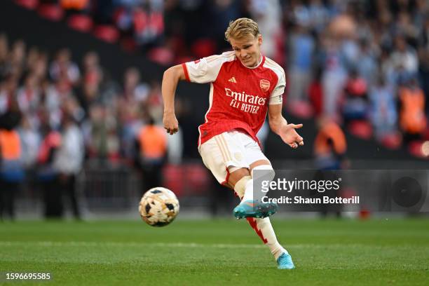 Martin Odegaard of Arsenal scores the team's first penalty in the penalty shoot out during The FA Community Shield match between Manchester City...