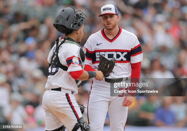 Chicago White Sox catcher Carlos Perez chats with Chicago White Sox relief pitcher Aaron Bummer during a Major League Baseball game between the...