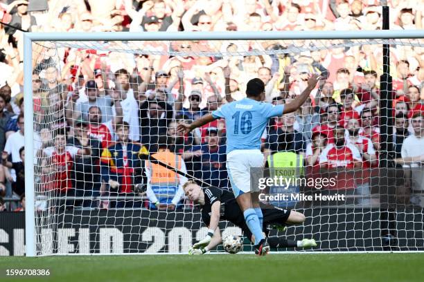 Aaron Ramsdale of Arsenal saves the third penalty from Rodri of Manchester City in the penalty shoot out during The FA Community Shield match between...