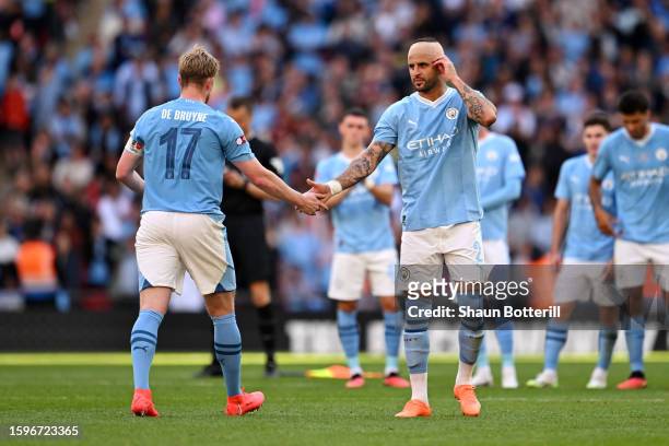 Kevin De Bruyne of Manchester City interacts with teammate Kyle Walker during the penalty shootout in The FA Community Shield match between...