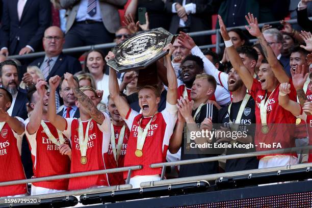Martin Odegaard of Arsenal lifts the FA Community Shield Trophy following the team's victory after a penalty shootout during The FA Community Shield...