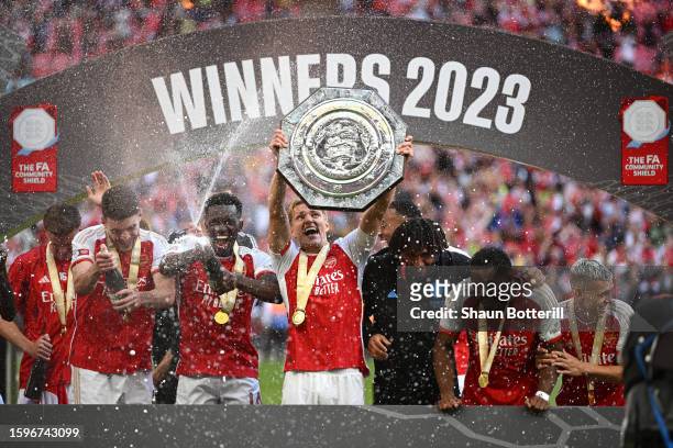 Martin Odegaard of Arsenal lifts the FA Community Shield Trophy following the team's victory after the penalty shootout during The FA Community...