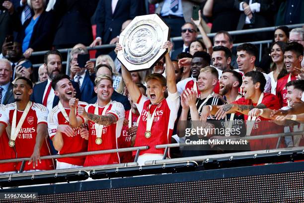 Martin Odegaard of Arsenal lifts the The FA Community Shield following The FA Community Shield match between Manchester City against Arsenal at...