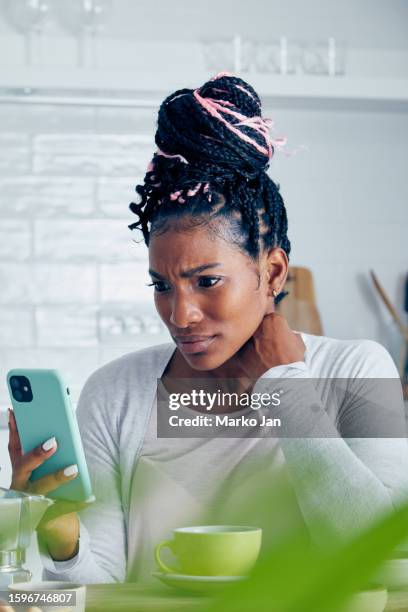 young woman in shock discovering a digital fraud - hoax stock pictures, royalty-free photos & images