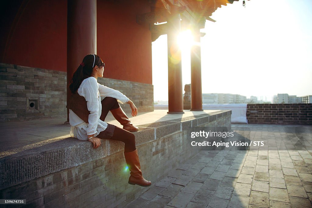 Relaxing outside a traditional Chinese building