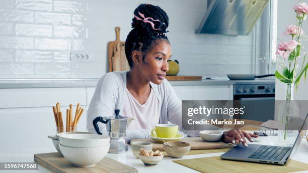 young woman in shock discovering a bank account fraud - romance fraud stock pictures, royalty-free photos & images