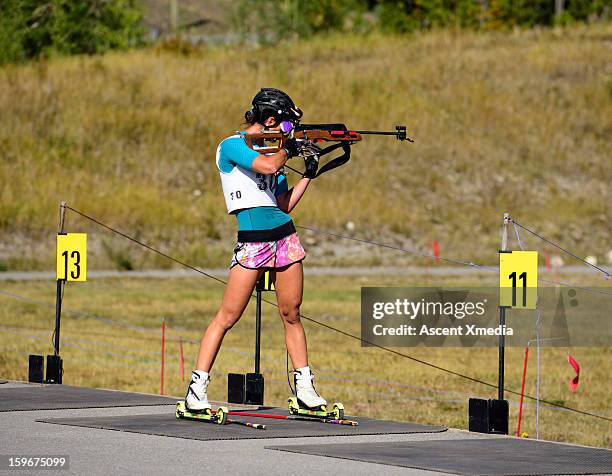 biathalon racer trains in summer, shooting range - target sport stock pictures, royalty-free photos & images