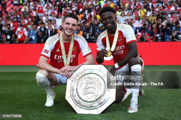 Declan Rice and Bukayo Saka of Arsenal pose for a photo with the FA Community Shield following The FA Community Shield match between Manchester City...