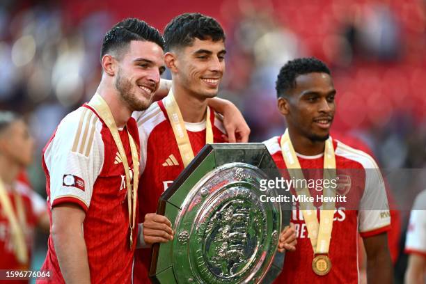 Declan Rice, Kai Havertz and Jurrien Timber of Arsenal pose for a photo with the FA Community Shield during The FA Community Shield match between...