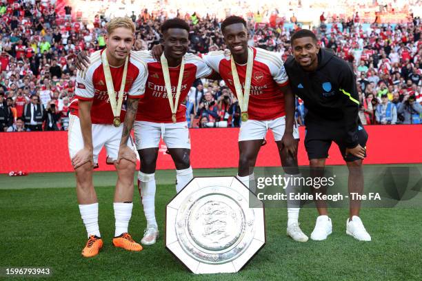 Emile Smith Rowe, Bukayo Saka, Edward Nketiah and Reiss Nelson of Arsenal pose for a photo with the FA Community Shield following The FA Community...