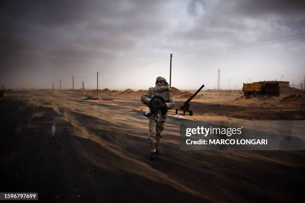 Libyan rebel fighter mans a check point in the stronghold oil town of Ras Lanuf on March 5, 2011 where up to 10 people were killed and more than 20...