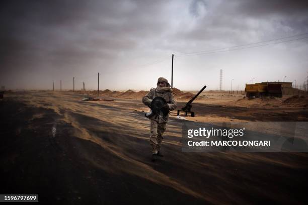 Libyan rebel fighter mans a check point in the stronghold oil town of Ras Lanuf on March 5, 2011 where up to 10 people were killed and more than 20...