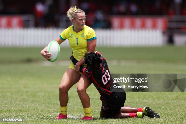 Heidi Dennis of Team Australia Women is tackled by Alisha Salandy of Team Trinidad & Tobago Women during the Rugby Sevens on day two of the 2023...